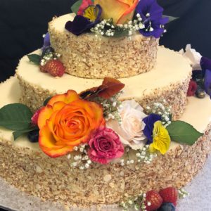 A baked walnut cake with edible flowers