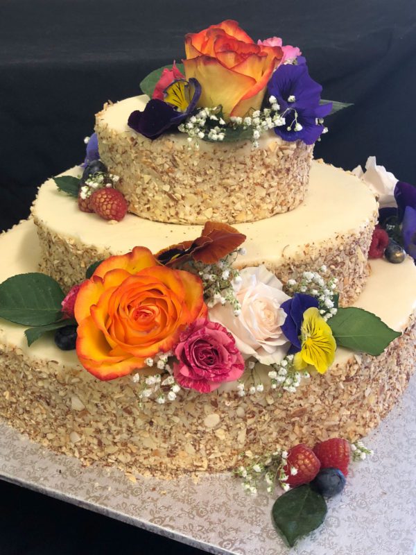 A baked walnut cake with edible flowers
